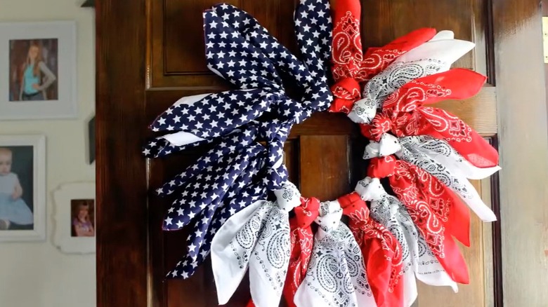A patriotic wreath is made from red, white, and blue vintage bandanas