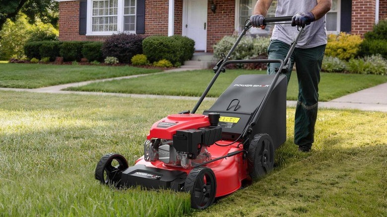 A man mowing his lawn with the PowerSmart 3-in-1 self-propelled mower
