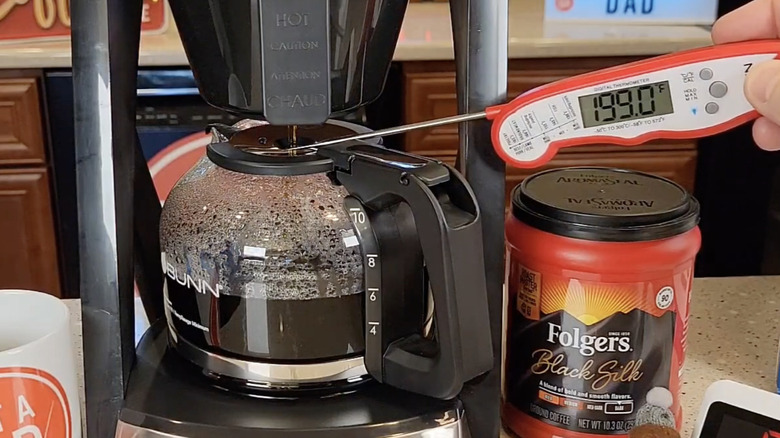 Homeowner measuring temperature in Bunn coffee maker