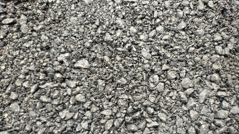 A large pile of asphalt millings ready for use.