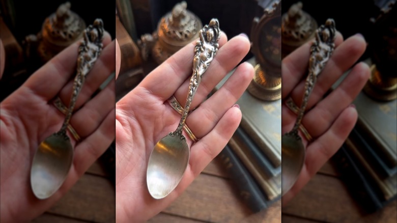 Person holding a Love Disarmed Reed and Barton spoon