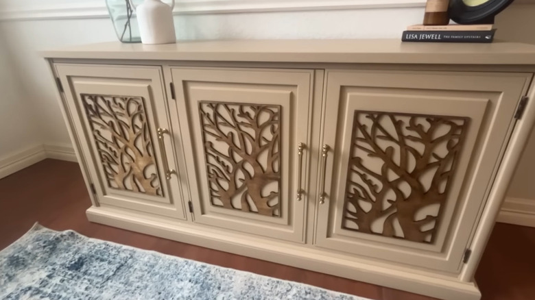 An old hutch repainted and decorated with panel inserts