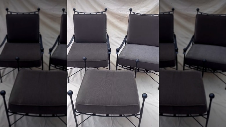 Two Salterini chairs with a matching ottoman on display