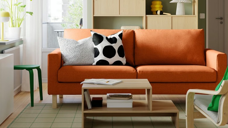A reddish-brown SALTSJÖBADEN sofa in a small living room