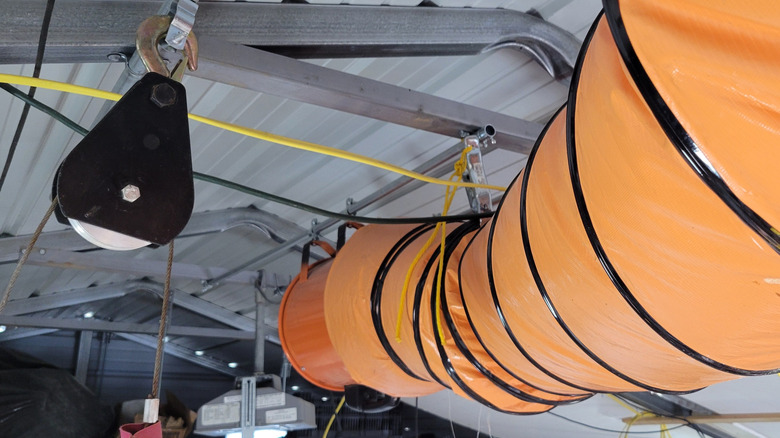 Flexible orange PVC ducting used to carry hot air to gable vent