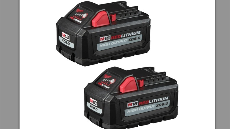 Milwaukee M18 batteries against a plain background