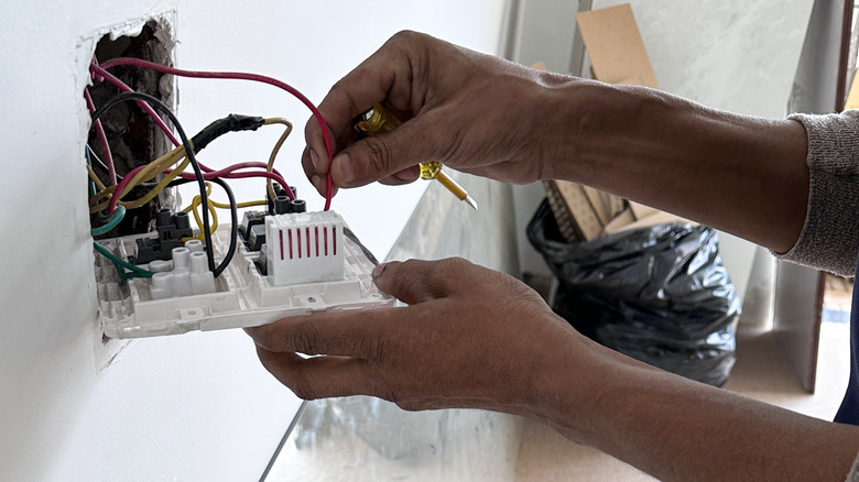 Electrician working on an outlet