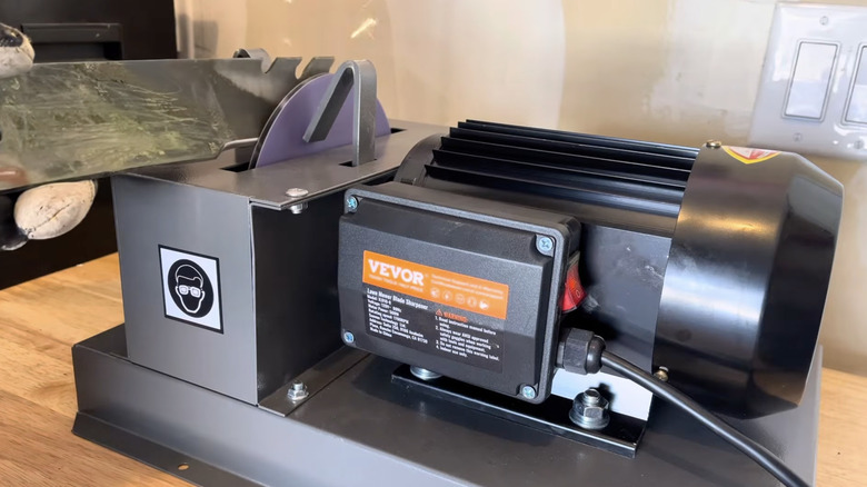 Homeowner using VEVOR lawn mower blade sharpener