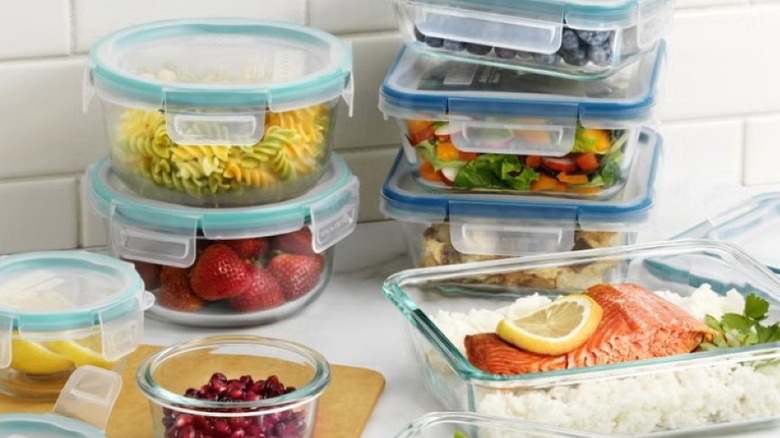 Food in Pyrex containers on a kitchen counter with a white backsplash
