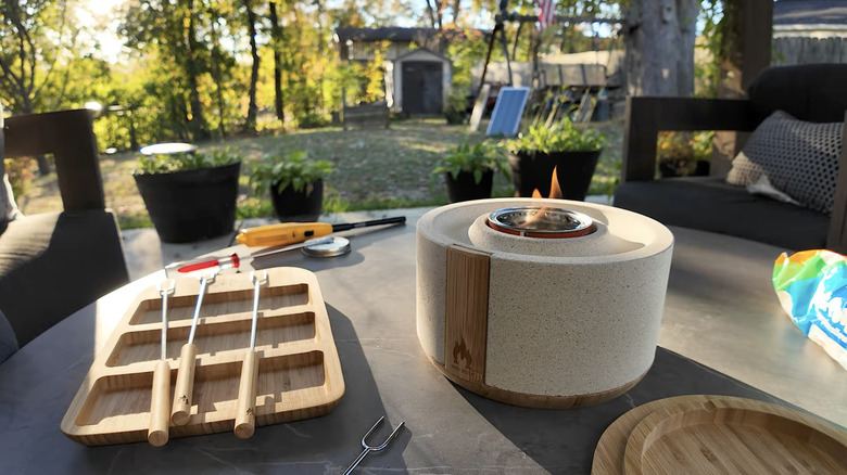Solo Stove S'mores Fire Bowl lit on patio table