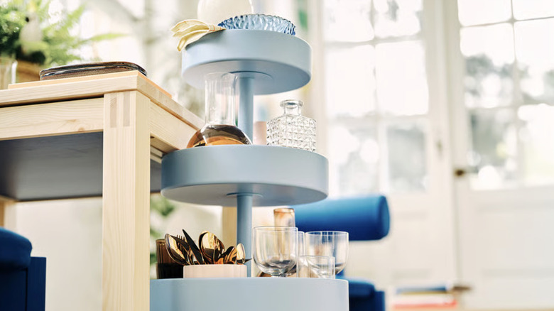 IKEA PS Utility Cart with dishes on it next to a dining table