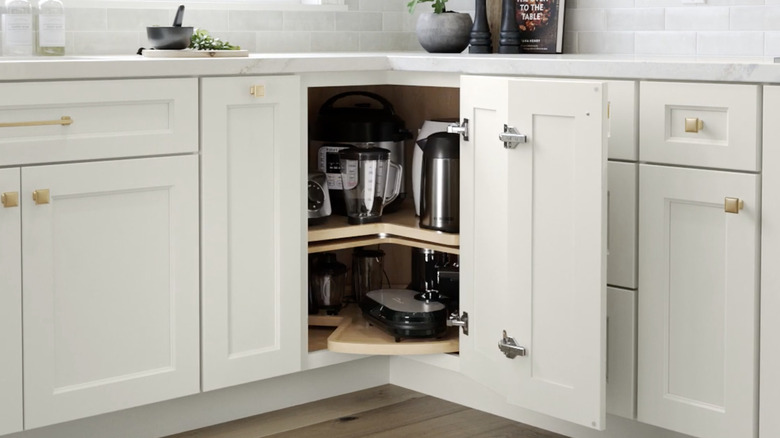 white corner cabinet with wood super Susan organizer installed inside