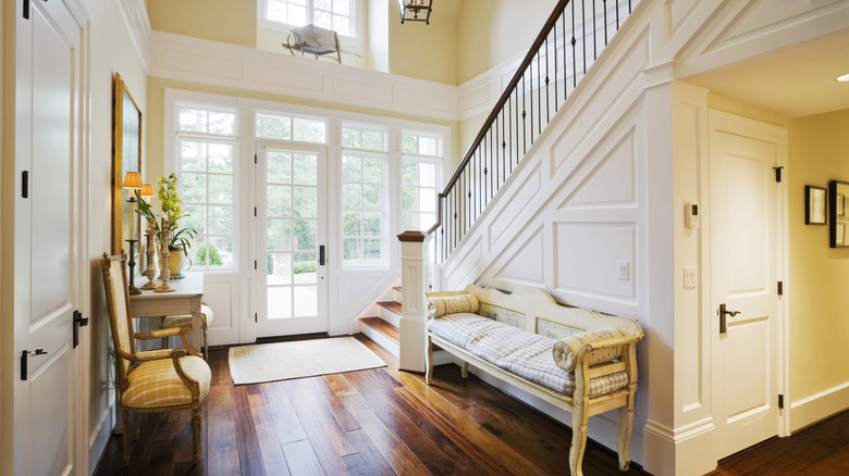 Inside a colonial style home with staircase near the front door