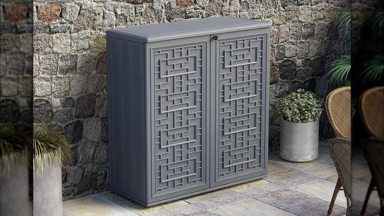 Mrosaa Outdoor Storage Cabinet on outdoor deck in front of rock wall