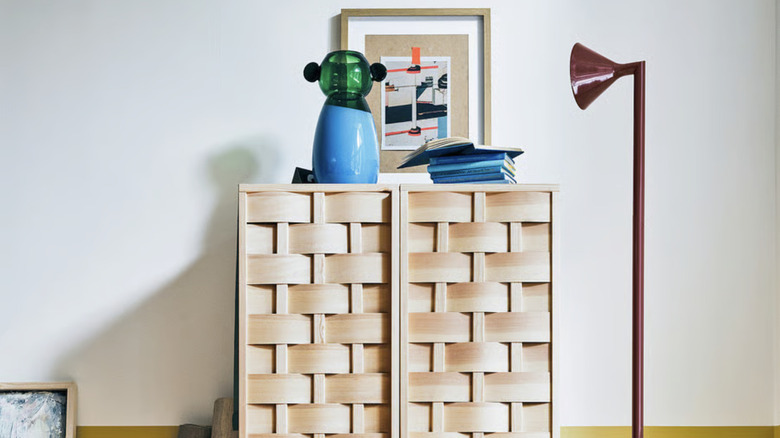 IKEA PS 2026 pine wood cabinet with decorative items around it