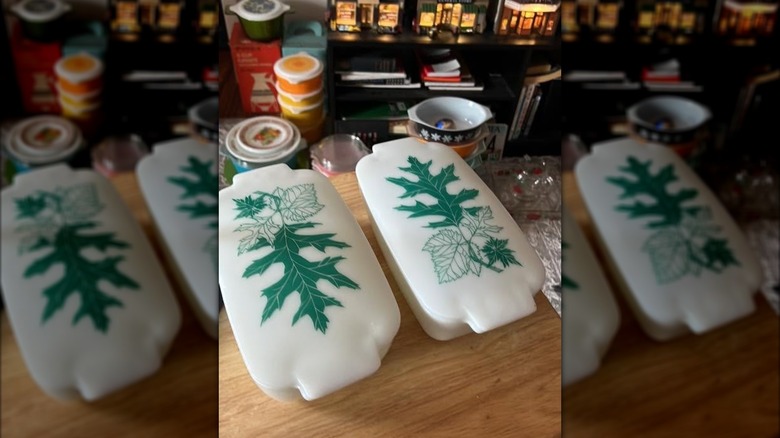 A pair of rare Pyrex Green Oak Leaf Loaf Pans on a table