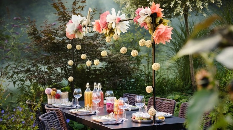 IKEA HELGEÖ Decorating rod decorated with paper flowers and string of lanterns