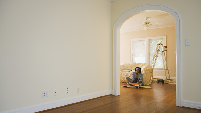 Woman working on renovations inside a home