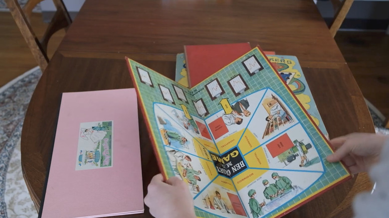 Hands folding a vintage game board
