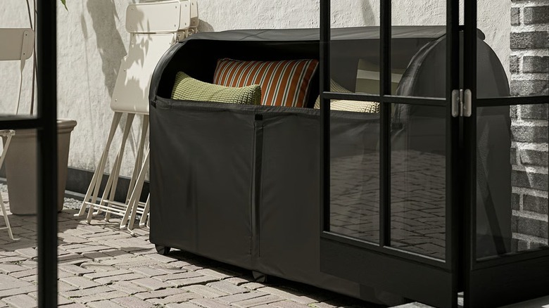 TOSTERÖ Storage box on patio with cushions inside
