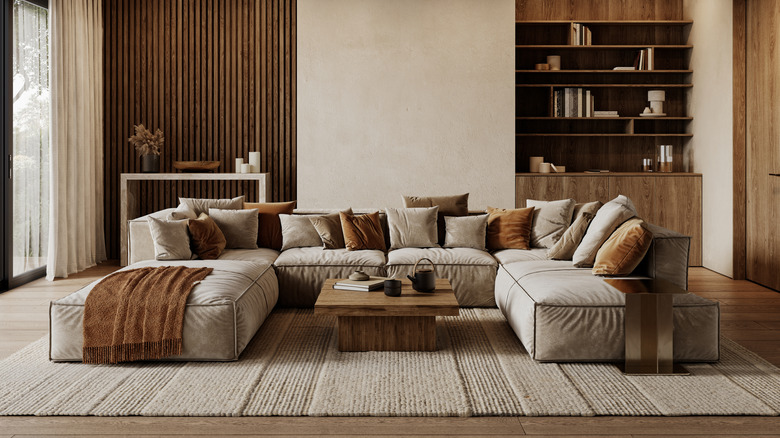 A modern yet cozy living room space with an oversized, taupe sofa.