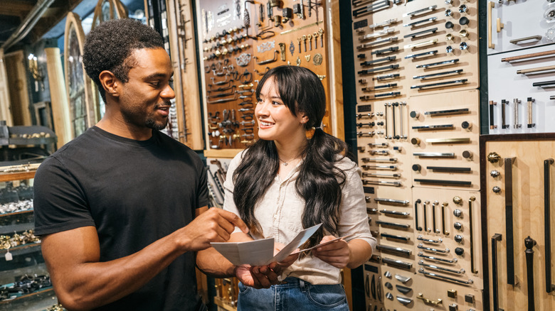 Couple looking at cabinet hardware at the store