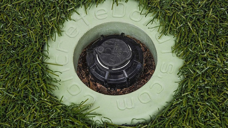 Sprinkler donut surrounding a sprinkler head in the grass