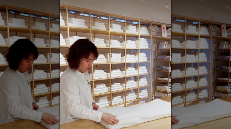 A woman in a store in Tokyo folds an Imabari towel