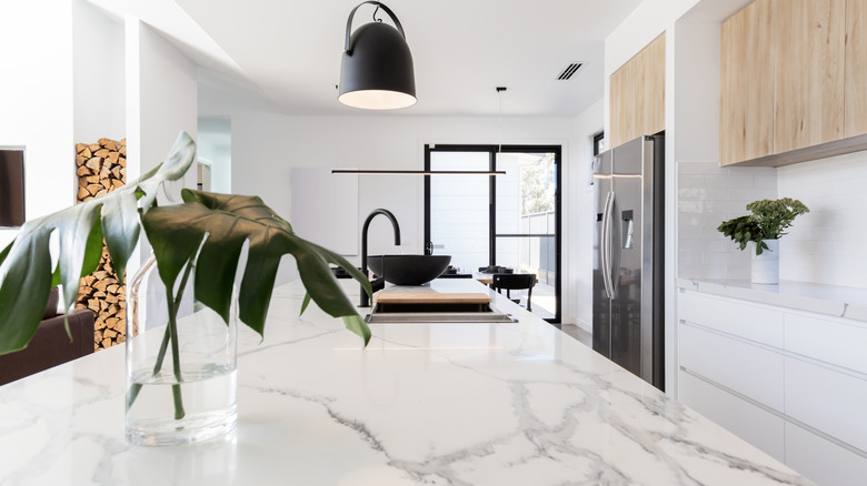 Modern kitchen island with a white marble countertop