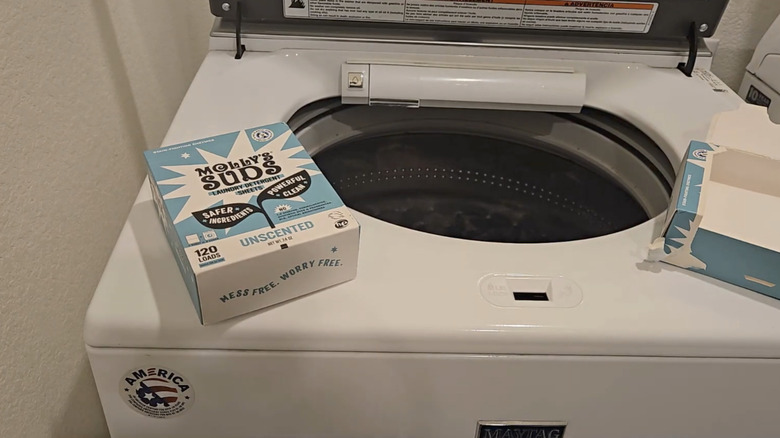 A box of Molly's Suds detergent sheets on a washer