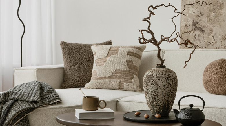 A modern living room with a mix of neutral throw pillows