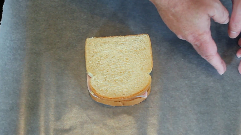 Sandwich lying on sheet of wax paper